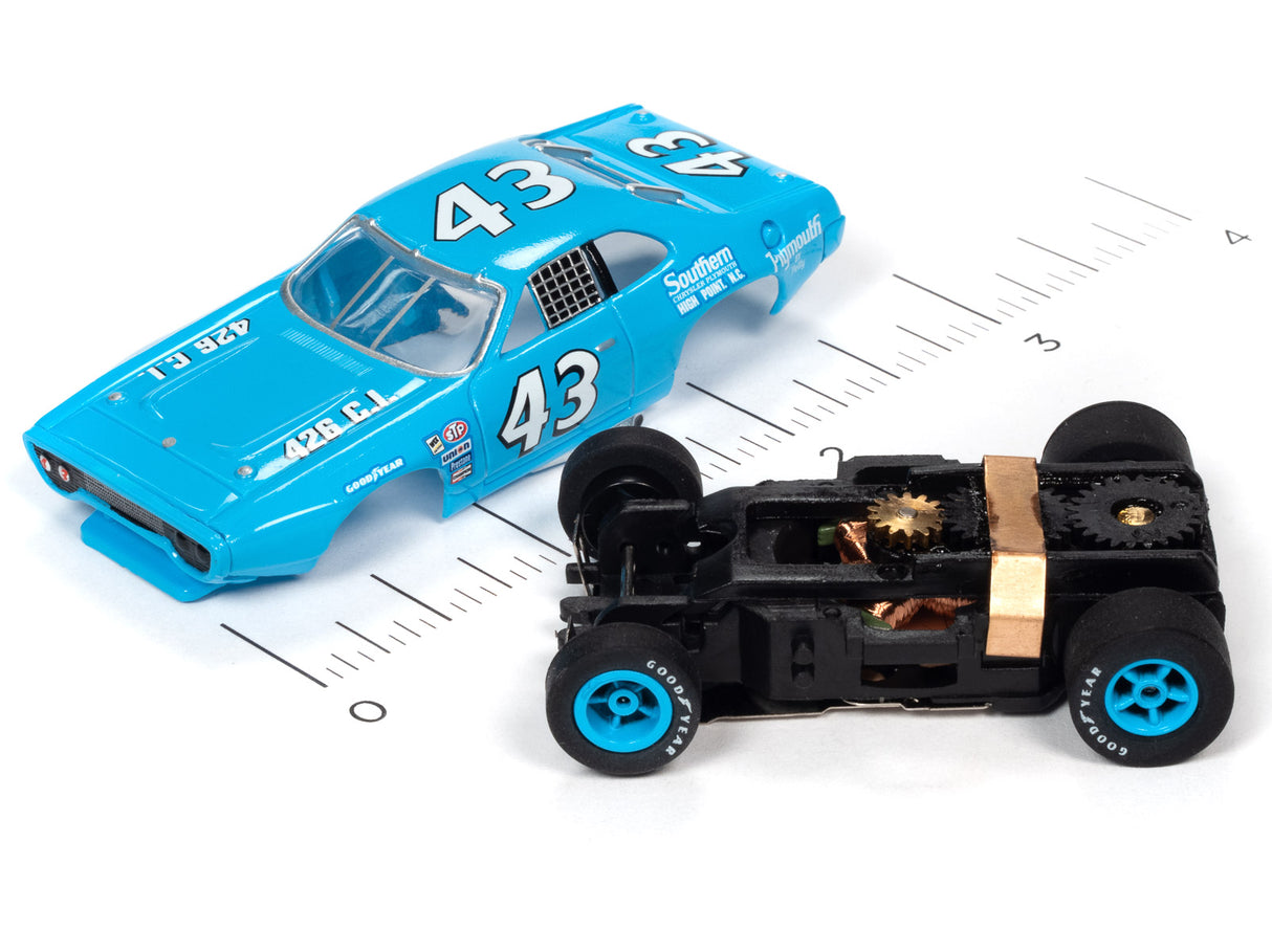 Blue race car and black toy car on a ruler background for Auto World SC355