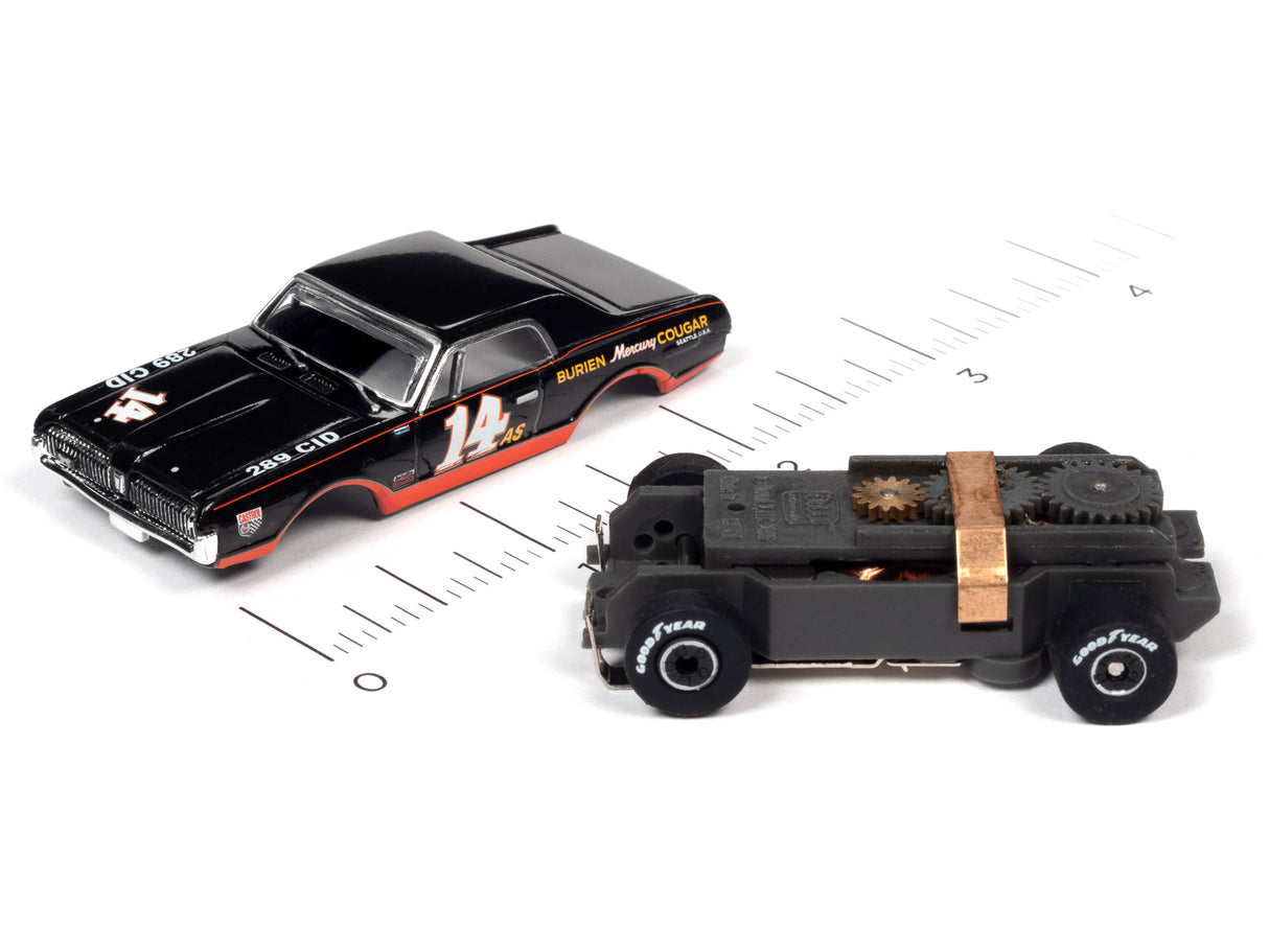 Two slot cars, a black coupe and a black jeep, on a ruler for Auto World SC357