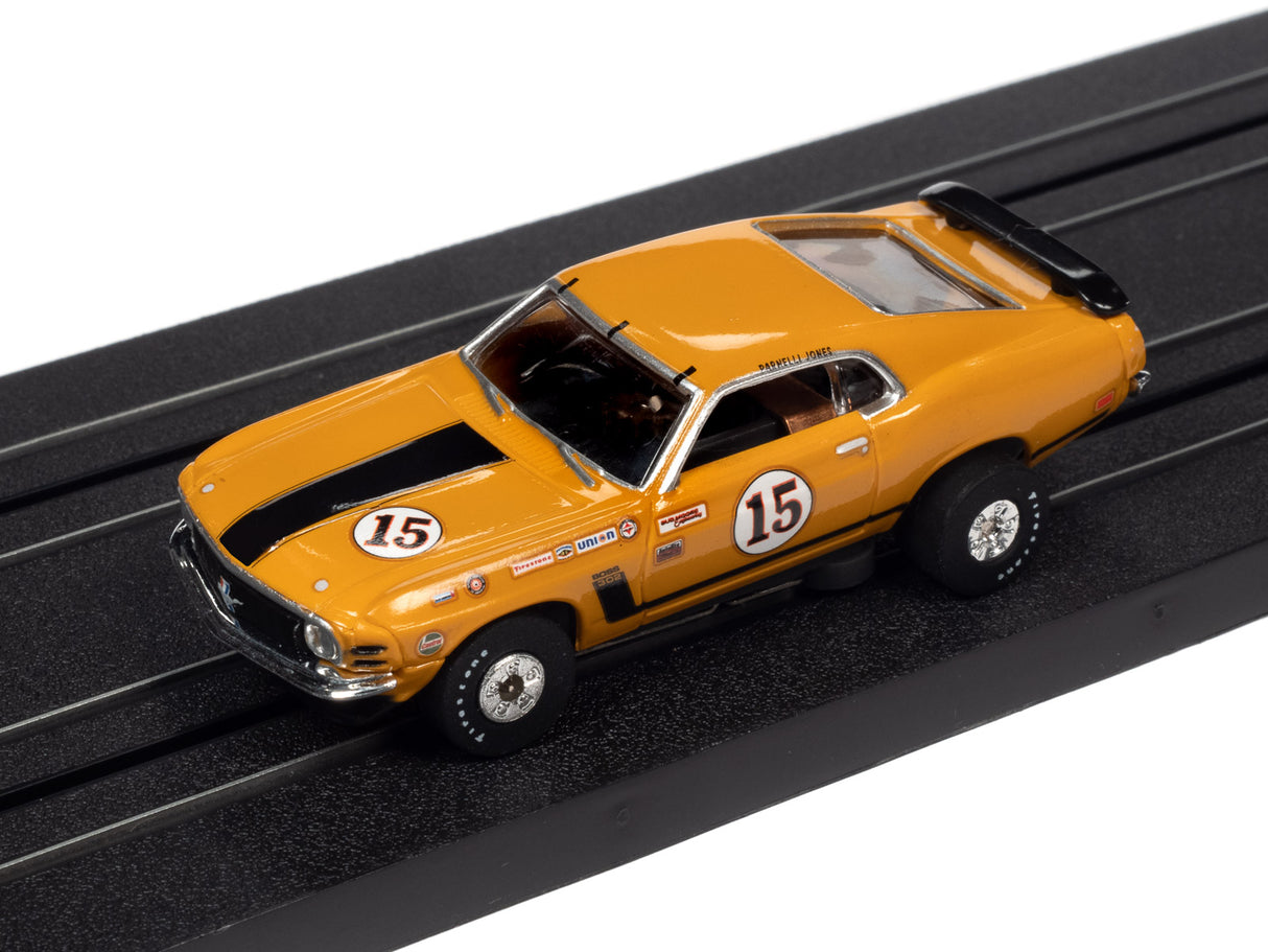 Yellow 1969 Camaro race car model on black track for Auto World SC357