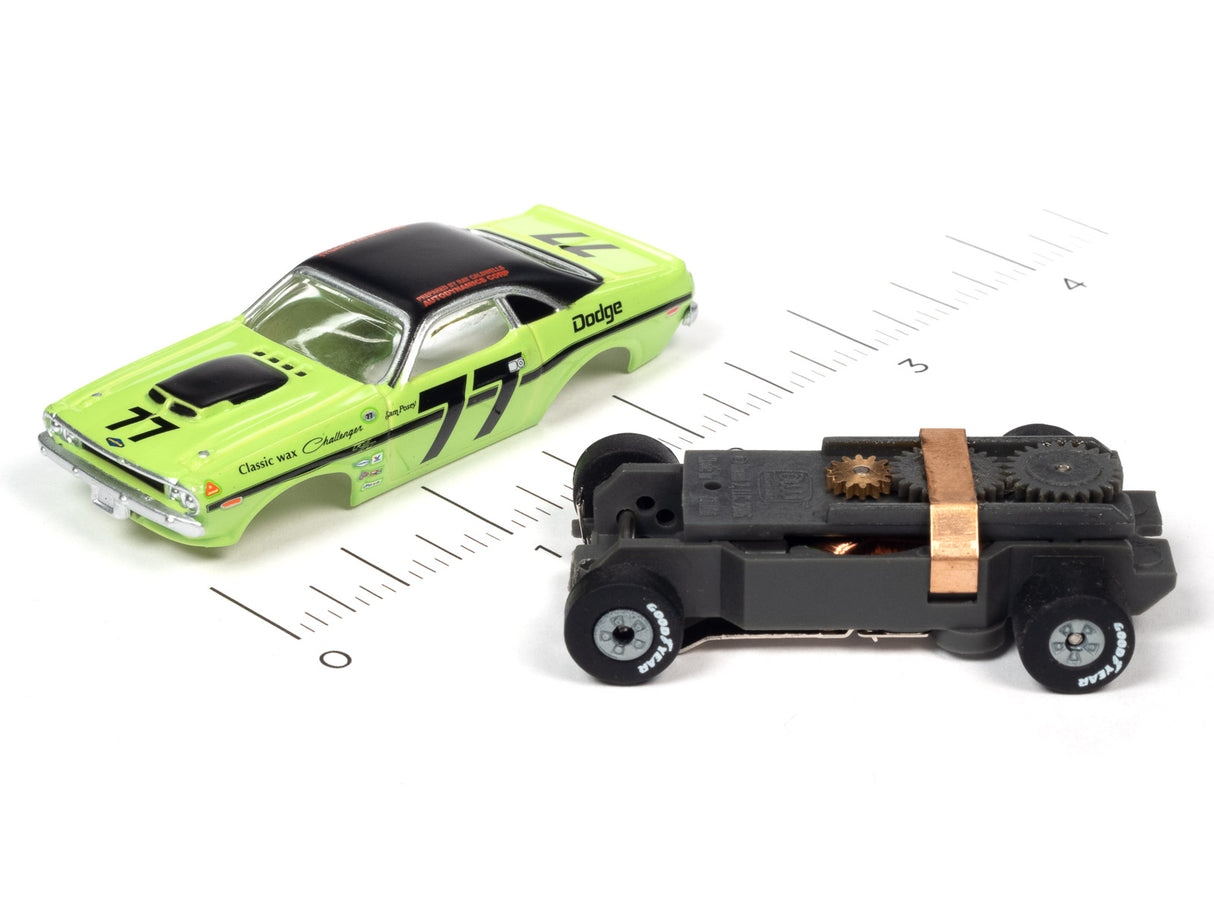 Slot cars: green Dodge and black, showing scale comparison for Auto World SC357