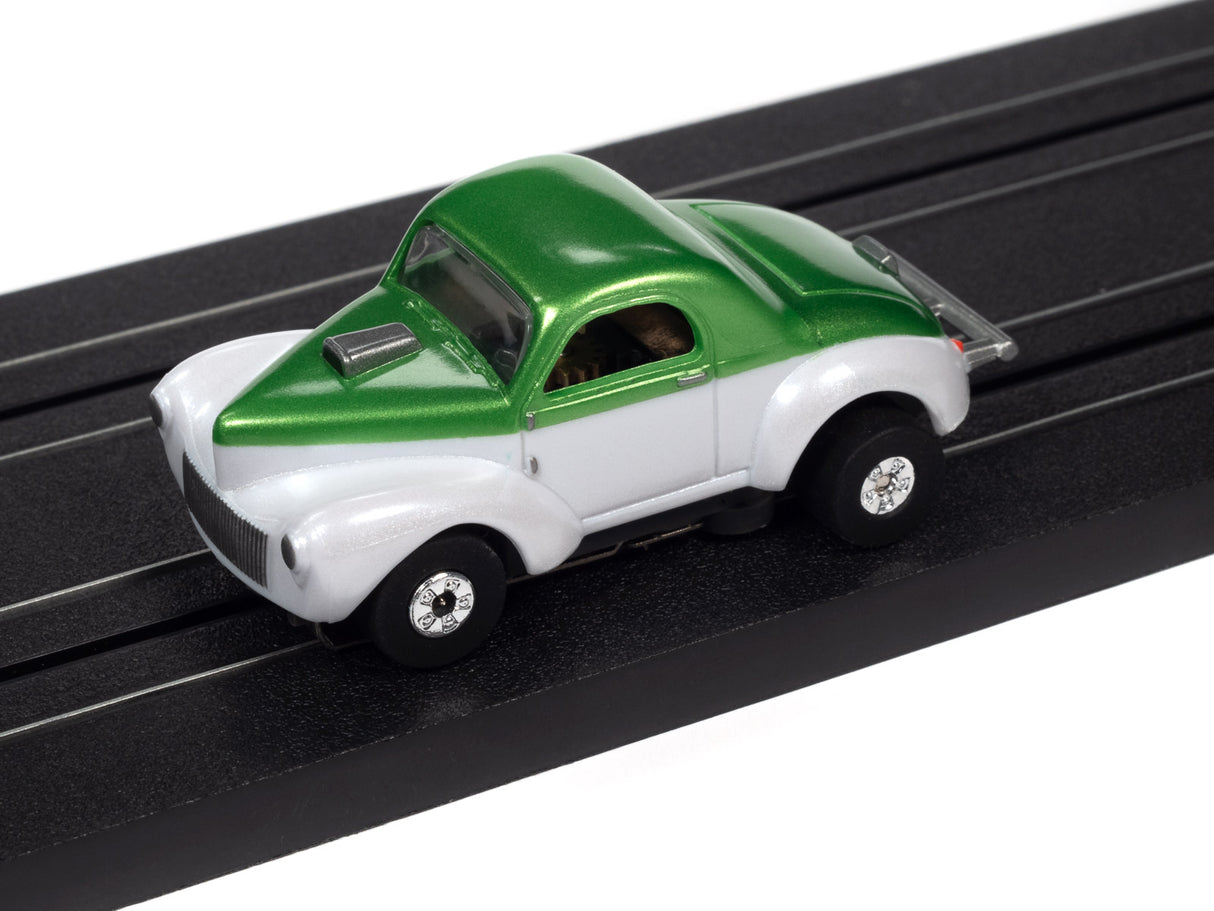 Green and white classic car toy on a black track for Auto World SC360