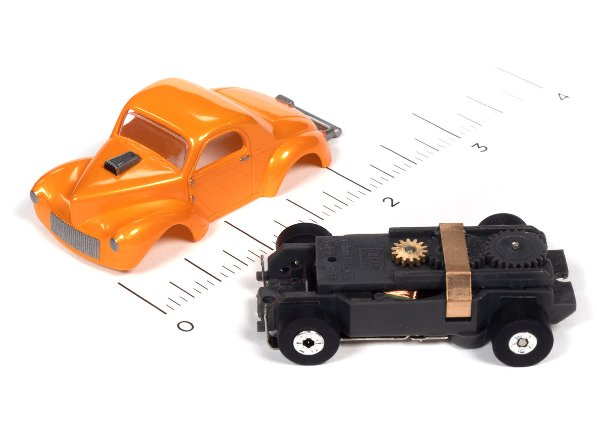 Orange and black toy cars on a ruler for scale for Auto World SC360