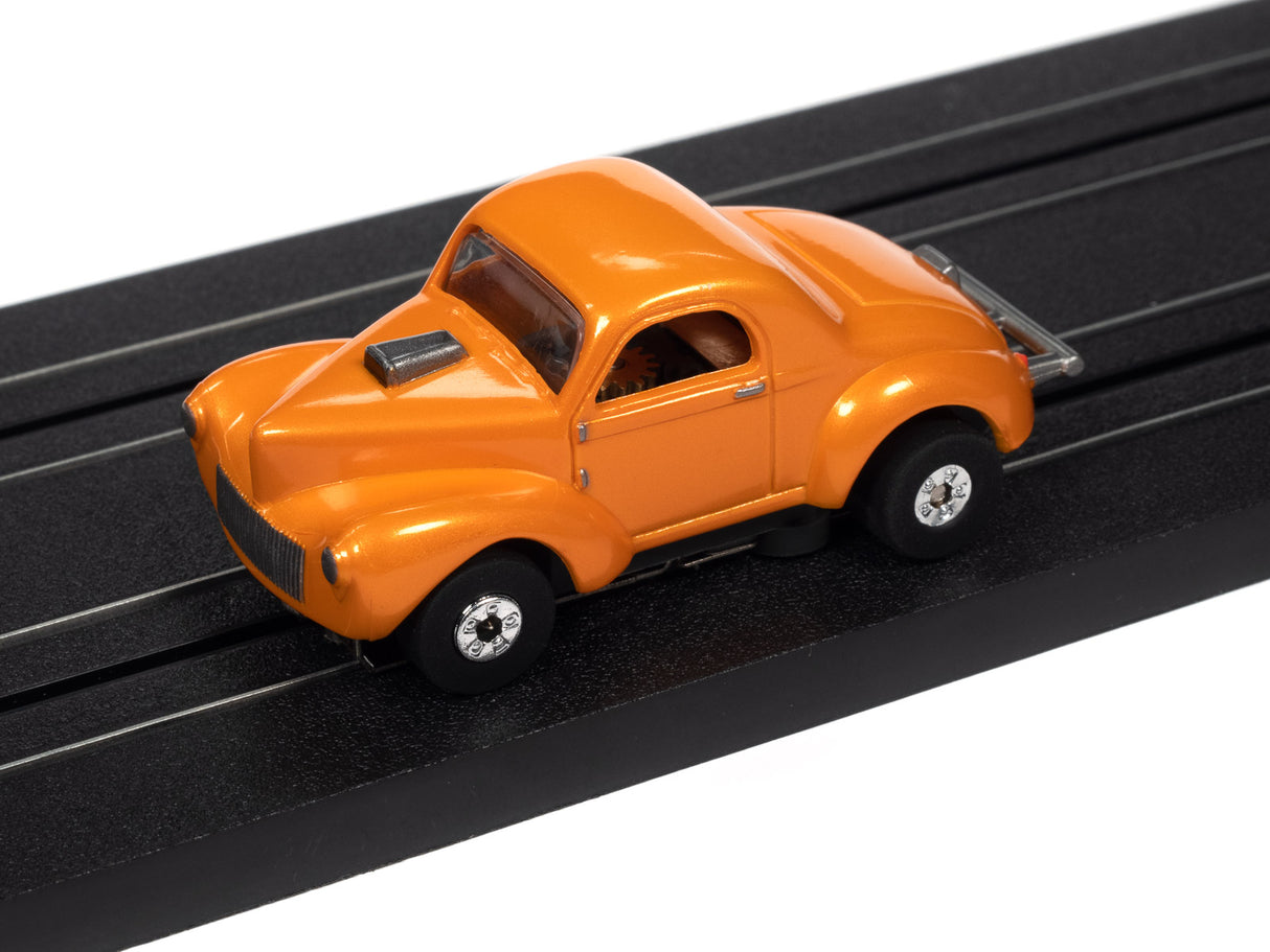 Orange slot car on a black track for Auto World SC360