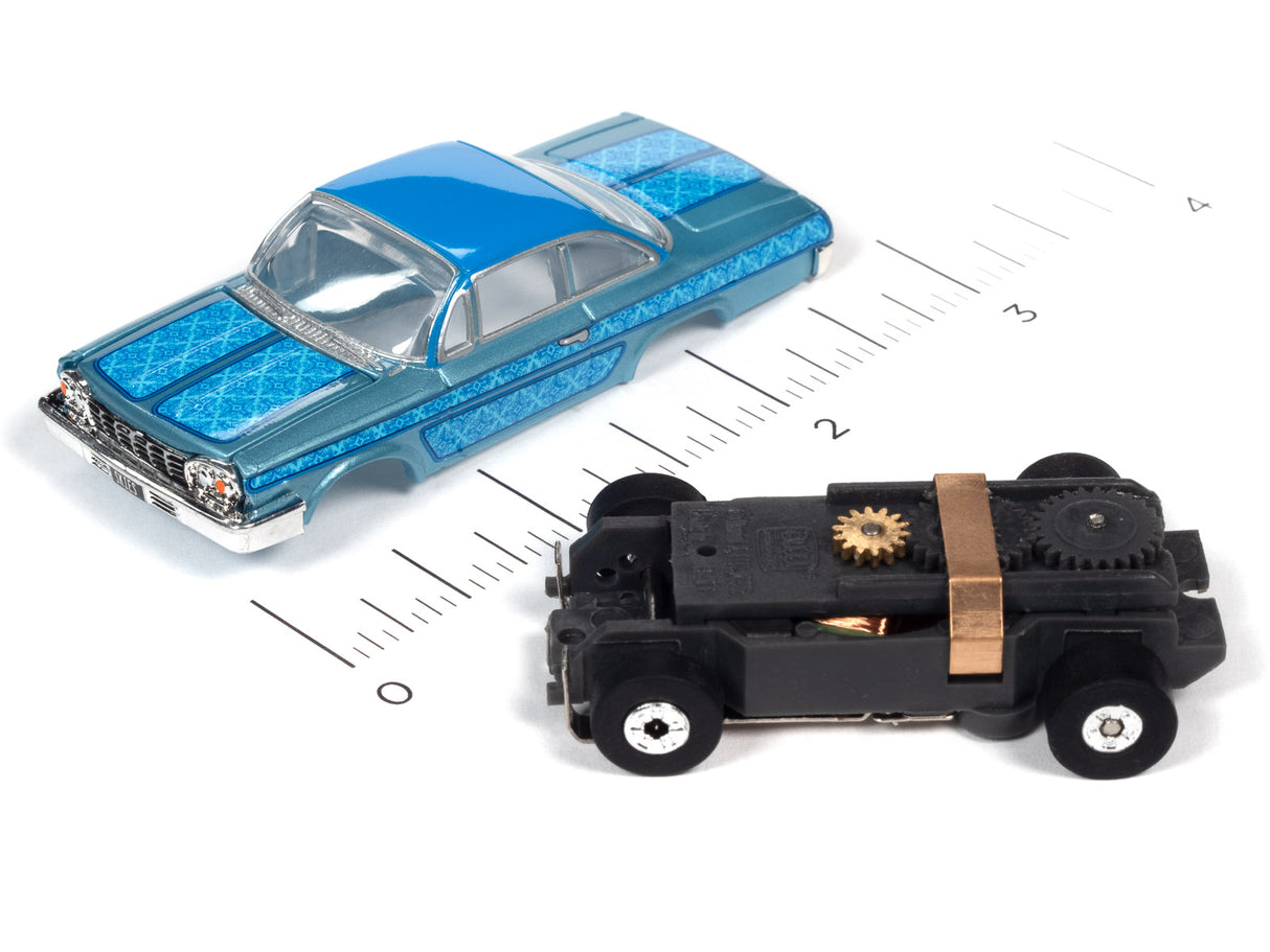 Blue classic car and black toy car on a ruler for Auto World SC360