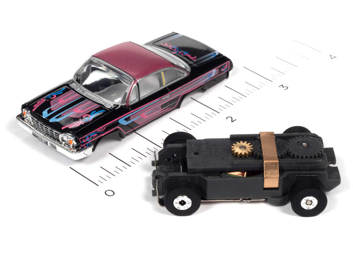 Slot cars: a black and pink car and a black, mechanical-looking car for Auto World SC360