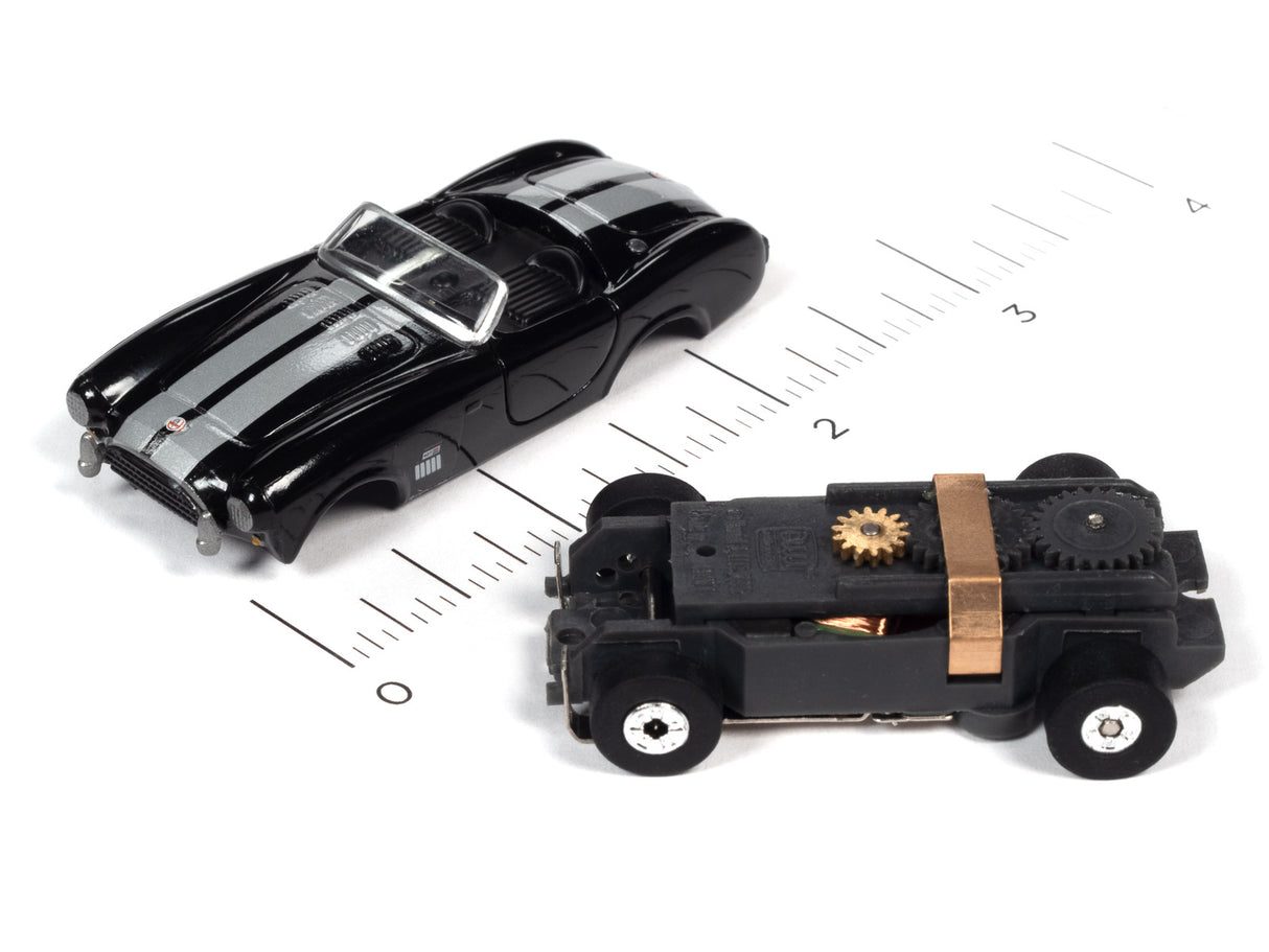 Black and black toy cars on a ruler scale for Auto World SC360