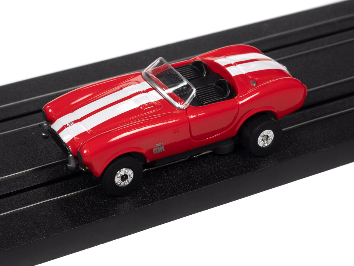 Red, open-top slot car on a black track for Auto World SC360