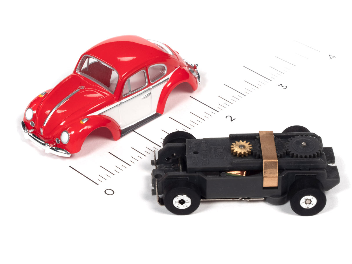 Red classic car and black toy car on a ruler for scale for Auto World SC360