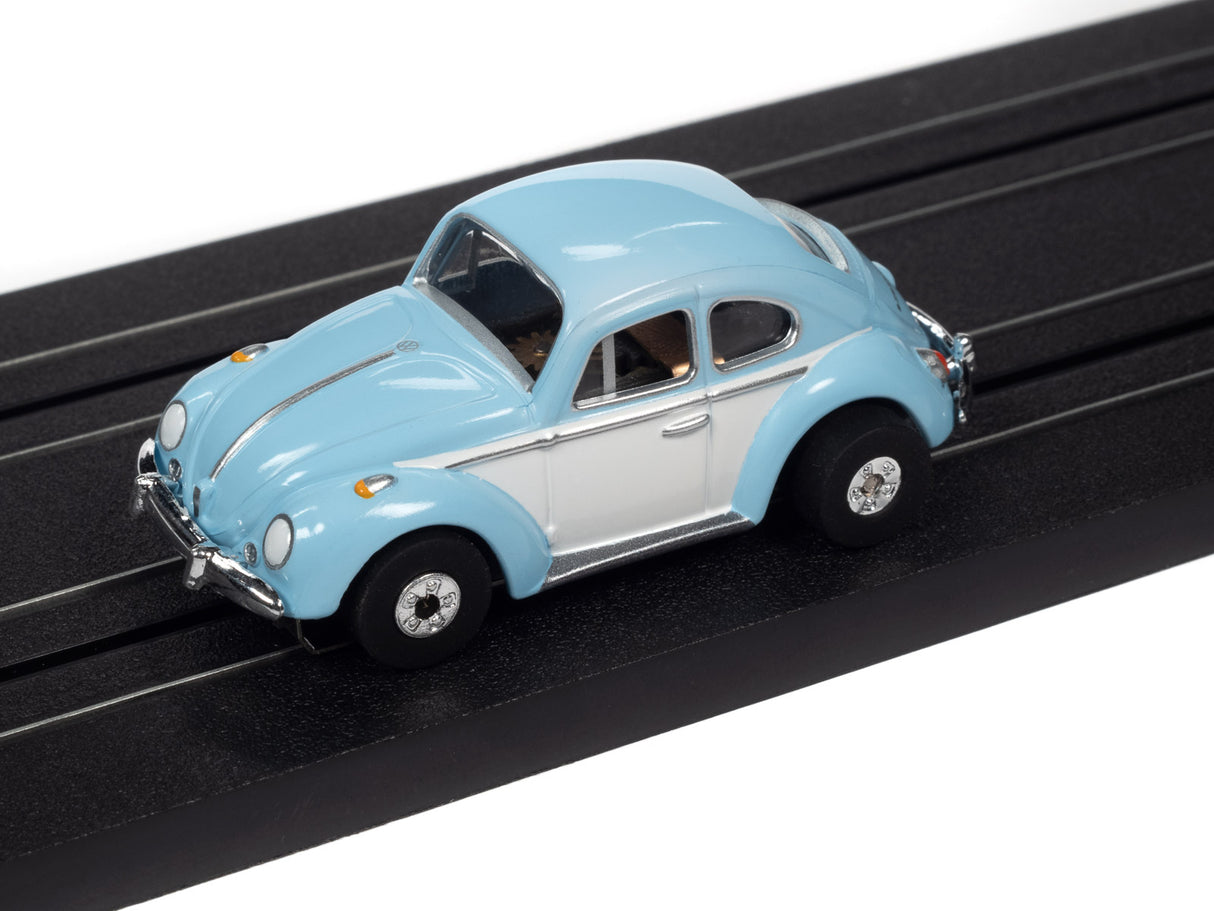 Light blue and white classic car toy on a black track for Auto World SC360
