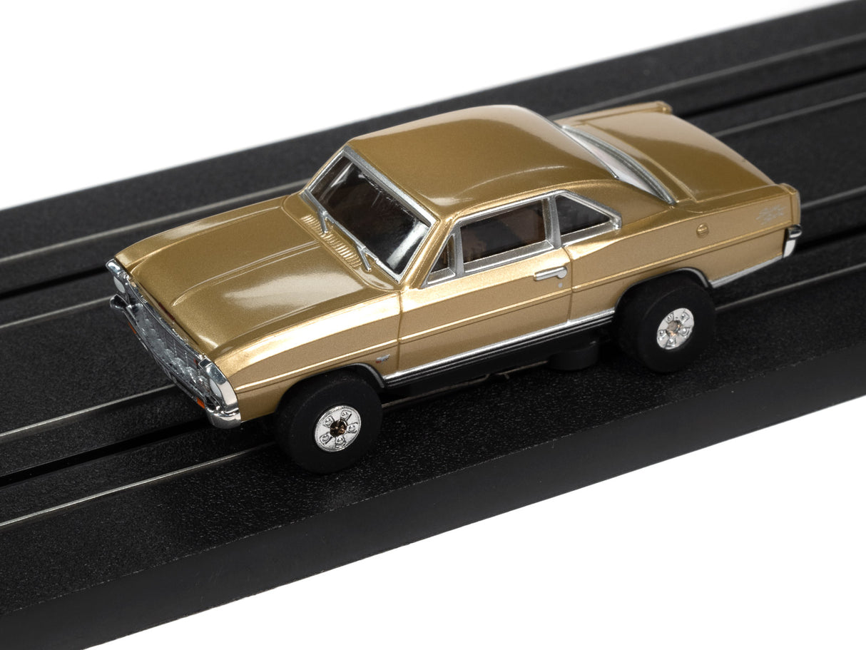 Gold slot car on a black display track for Auto World SC360