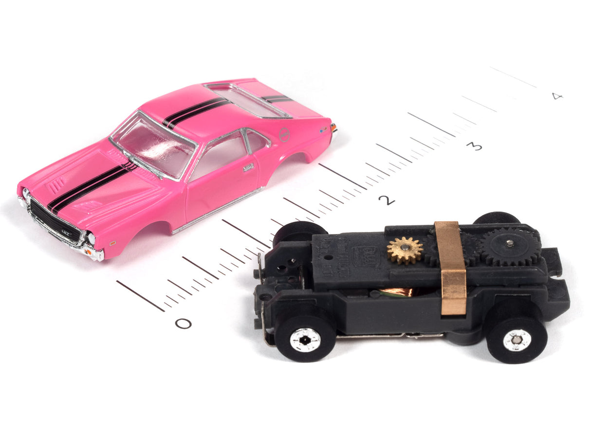 Pink and black slot cars on a ruler for scale for Auto World SC360