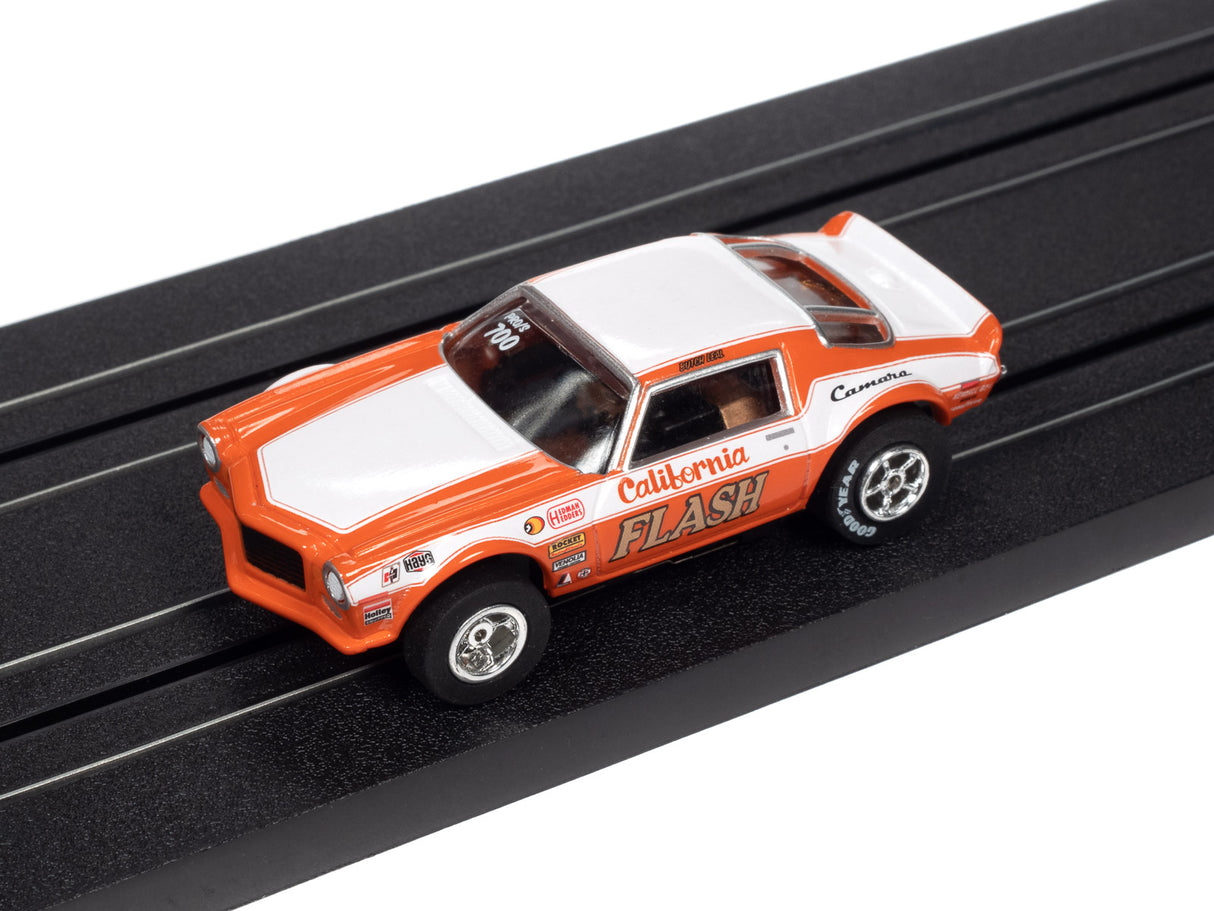 Orange and white slot car race car on a black track for Auto World SC361