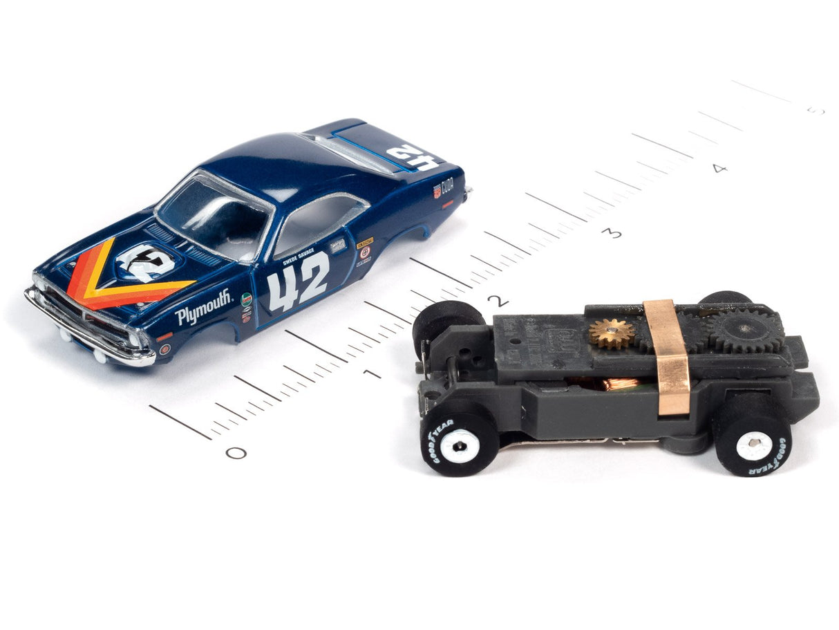 Slot cars: blue Plymouth and black race car on a ruler for Auto World SC362