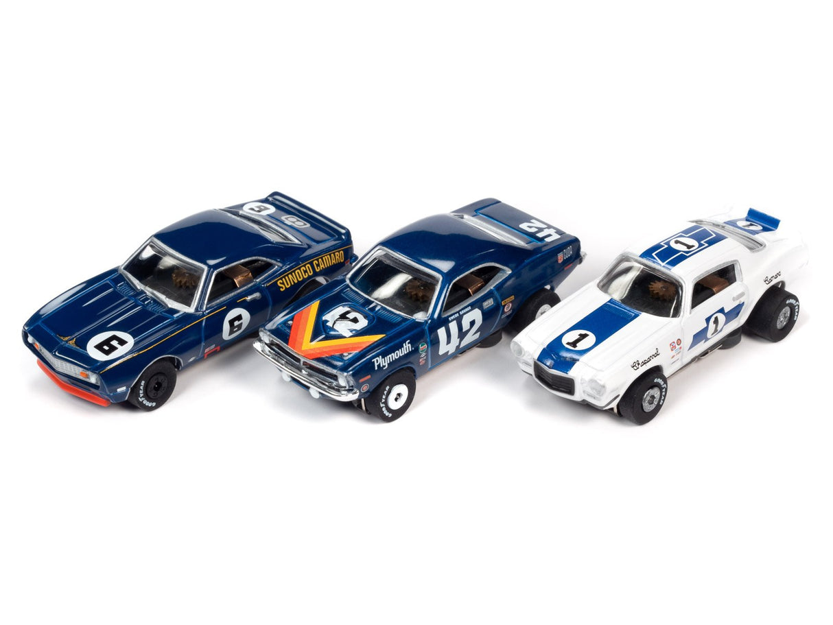 Three slot car race cars: blue, dark blue, and white for Auto World SC362, rear view