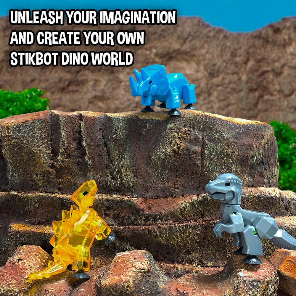 Three small, colorful dinosaur figures on a rocky surface for Zing 90644