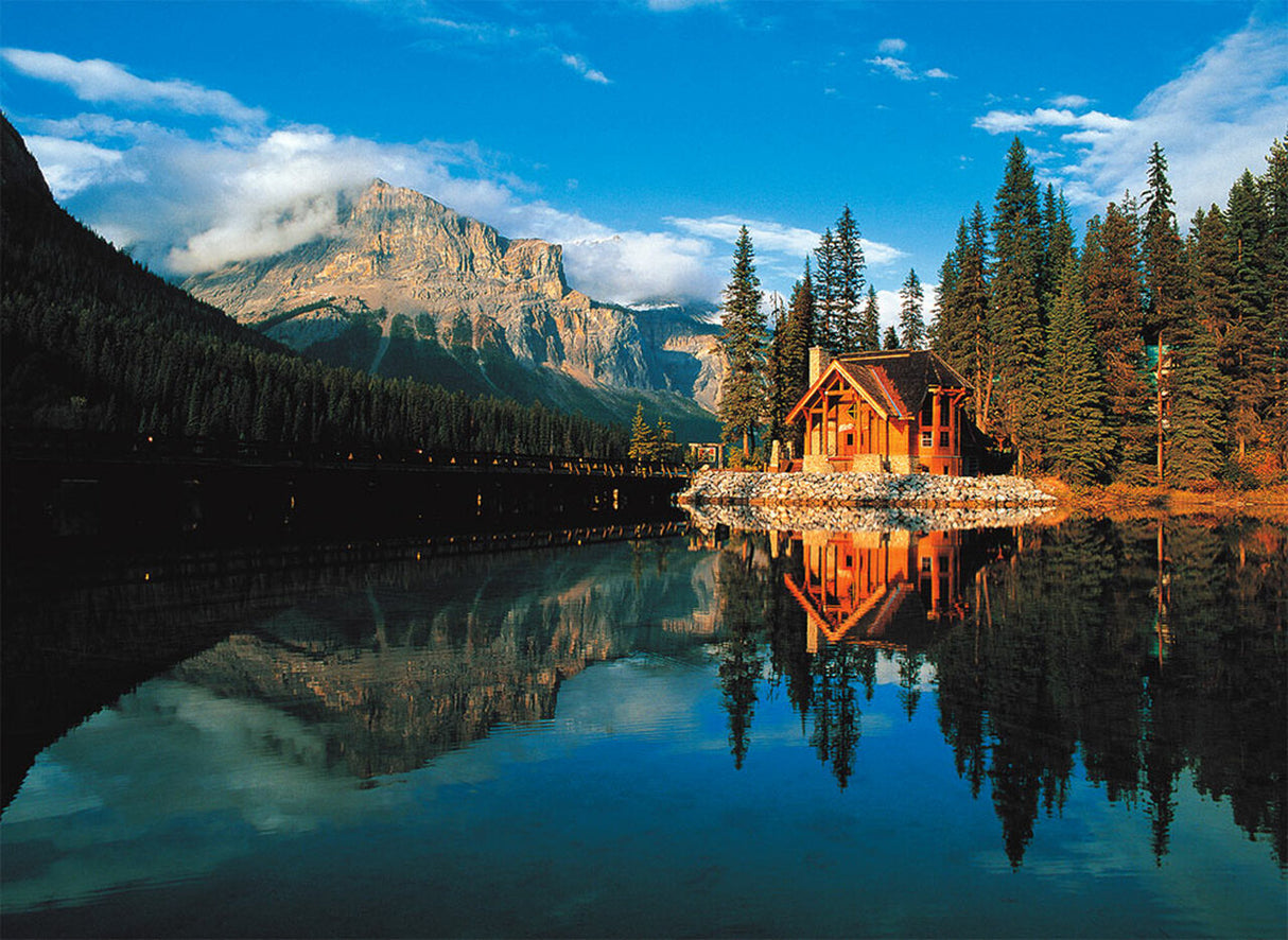 Cabin reflected in calm water with mountains and forest backdrop for Tomax TOM50-045