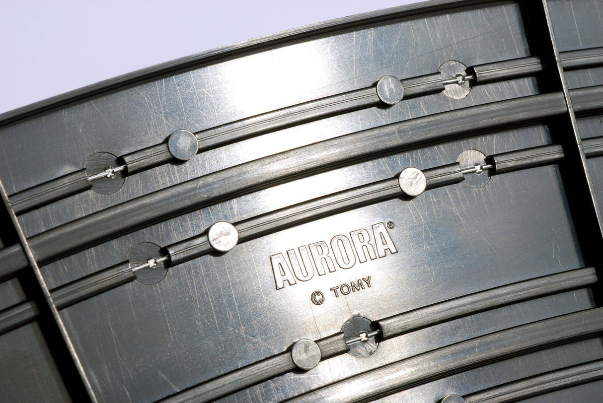 Close-up of a metal camera lens barrel with visible markings for AFX RaceMaster 70621