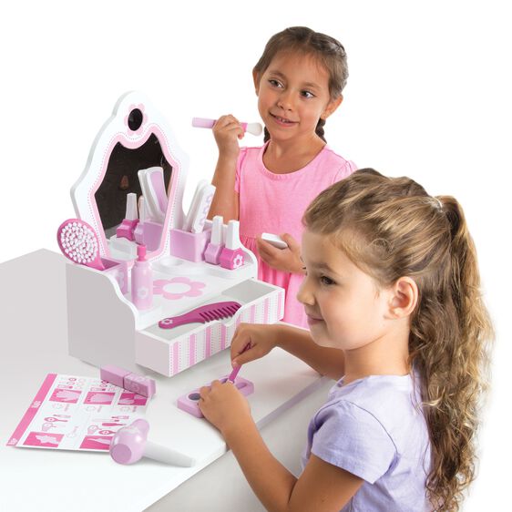 Two girls play with a pink beauty salon play set containing tools and accessories for Melissa and Doug 3026