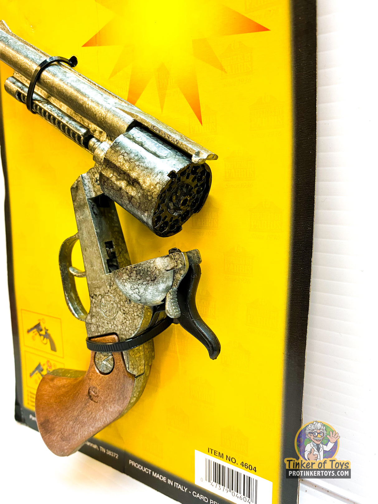 Toy replica pistols displayed on a yellow cardboard backing for Parris Toys 4604