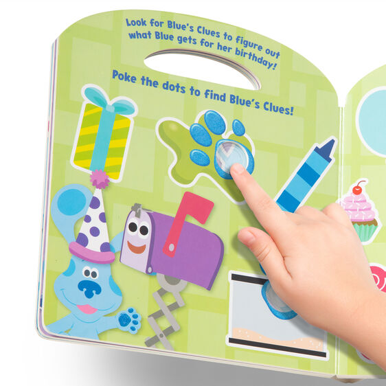 Child's hand points to a dot on a book page featuring Blue's Clues for Melissa and Doug 33006