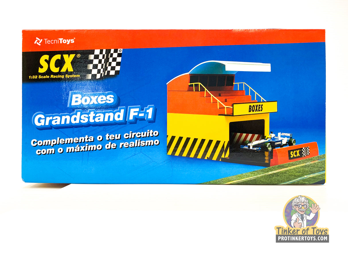 Scale model display for F-1 racing, featuring grandstands and pit boxes for SCX 88260