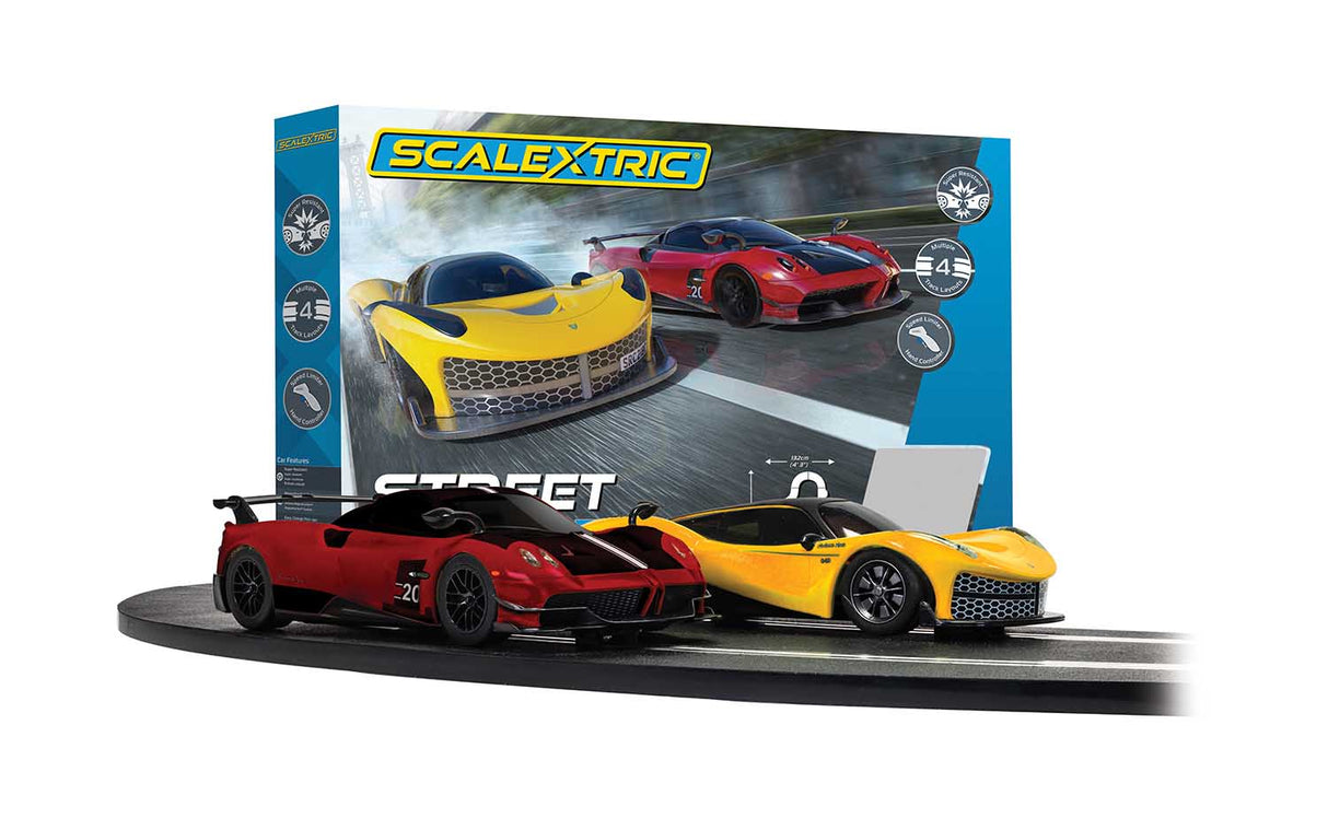 Three slot car race cars on a track set with box art for Scalextric 1/32 C1422T