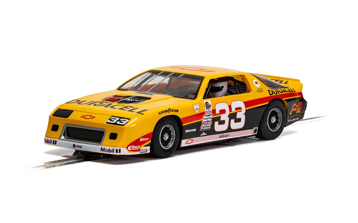 Yellow Chevrolet Camaro IROC slot car, number 33, on a track for Scalextric 1/32 Slot Car C4220