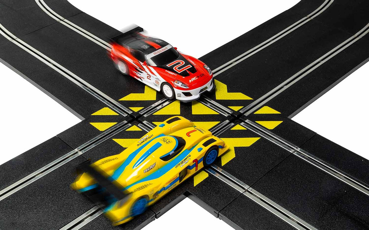 Race cars crossing a black and yellow track junction for Scalextric C8215