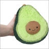 Stuffed avocado toy, green exterior with brown center, held in a hand for Squishable 104349