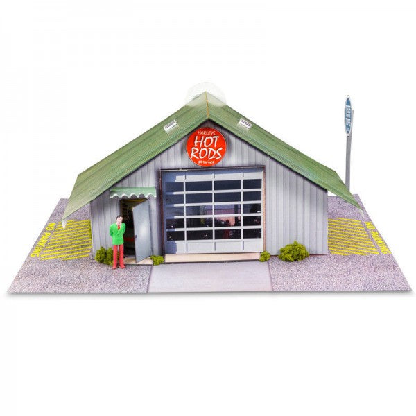 Model kit of a hot rod garage with a figure standing outside for Innovative Hobby Supply BK3210