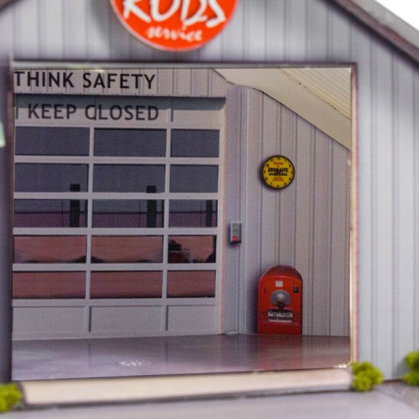 Garage door with "THINK SAFETY KEEP CLOSED" sign and red mailbox for Innovative Hobby Supply BK3210
