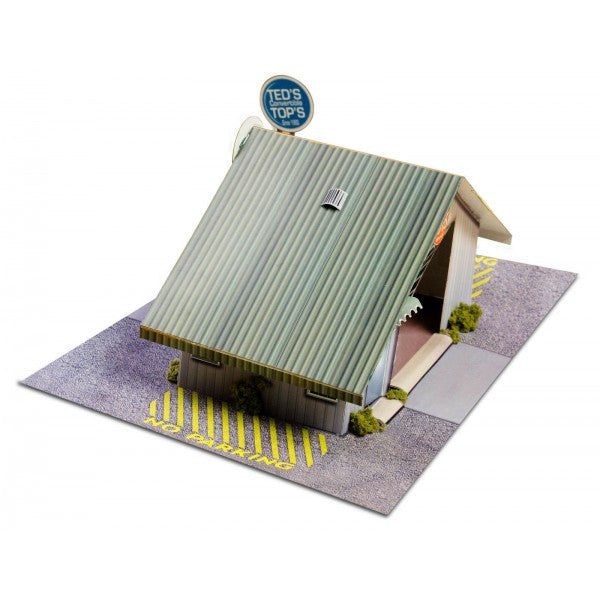 Model kit of a commercial steel garage with a sign for Innovative Hobby Supply BK3210, rear view