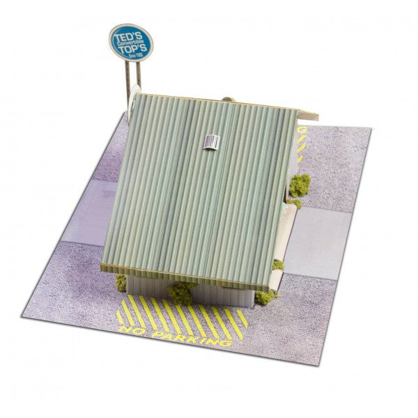 Model kit of a commercial steel garage building on a paved base for Innovative Hobby Supply BK3210