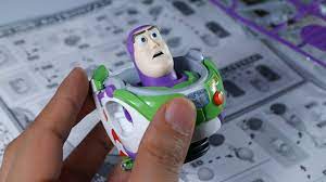 Hand holding a Buzz Lightyear model kit, ready for assembly for Bandai 27731