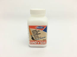 White bottle of wood sealer for sealing porous wood surfaces for Deluxe DLMBD49