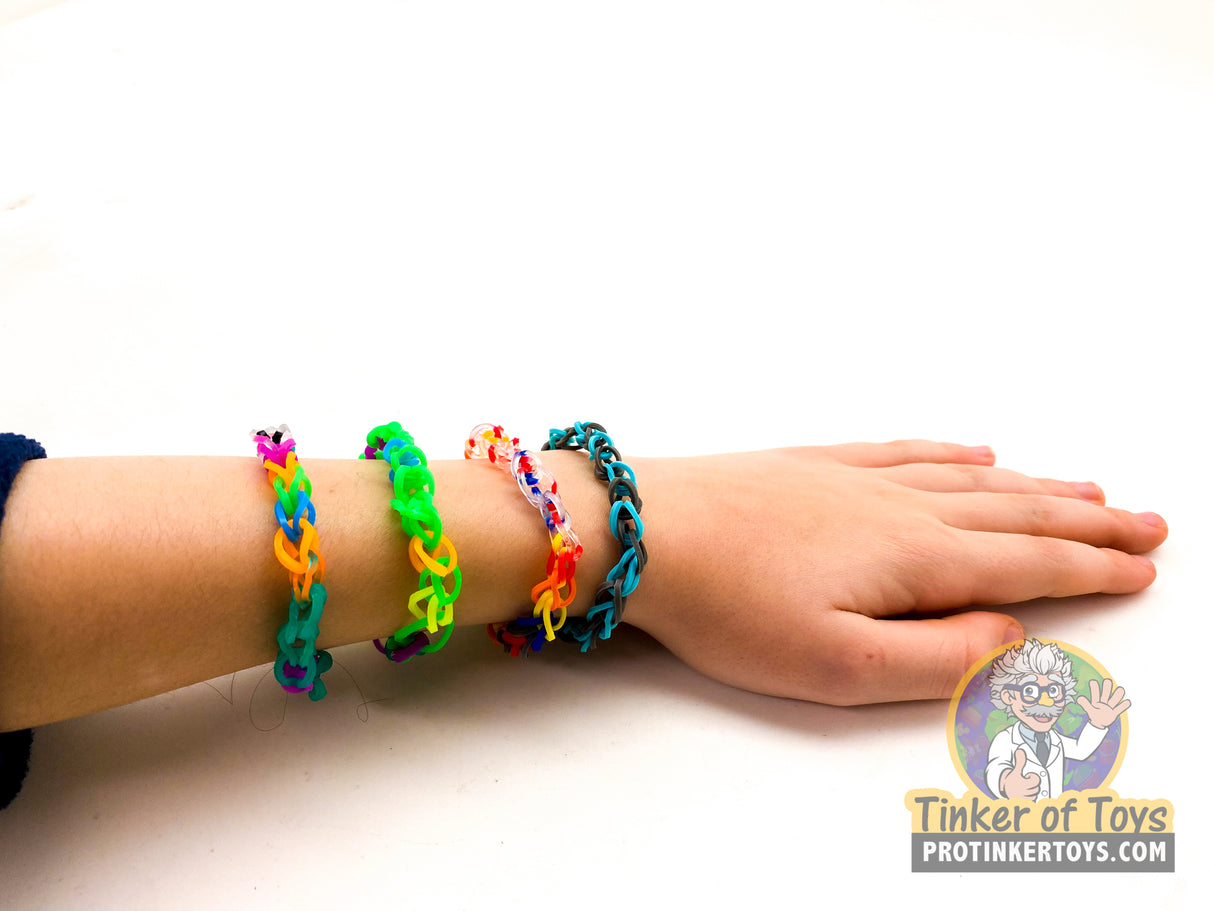Assorted colorful rainbow loom bracelets worn on a wrist