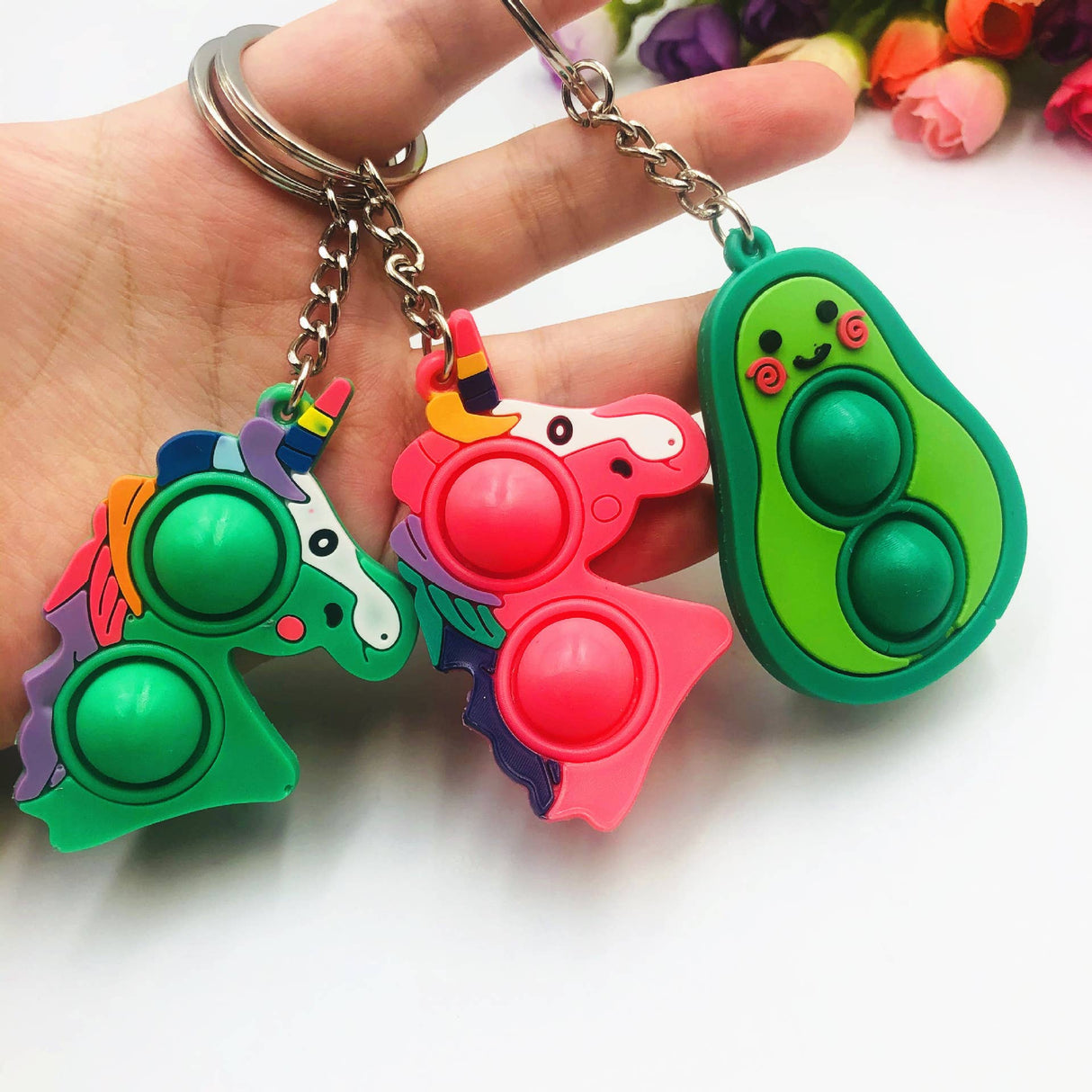 Colorful pop it keychain fidget toys: unicorn, avocado, and another animal for Faire FH2928