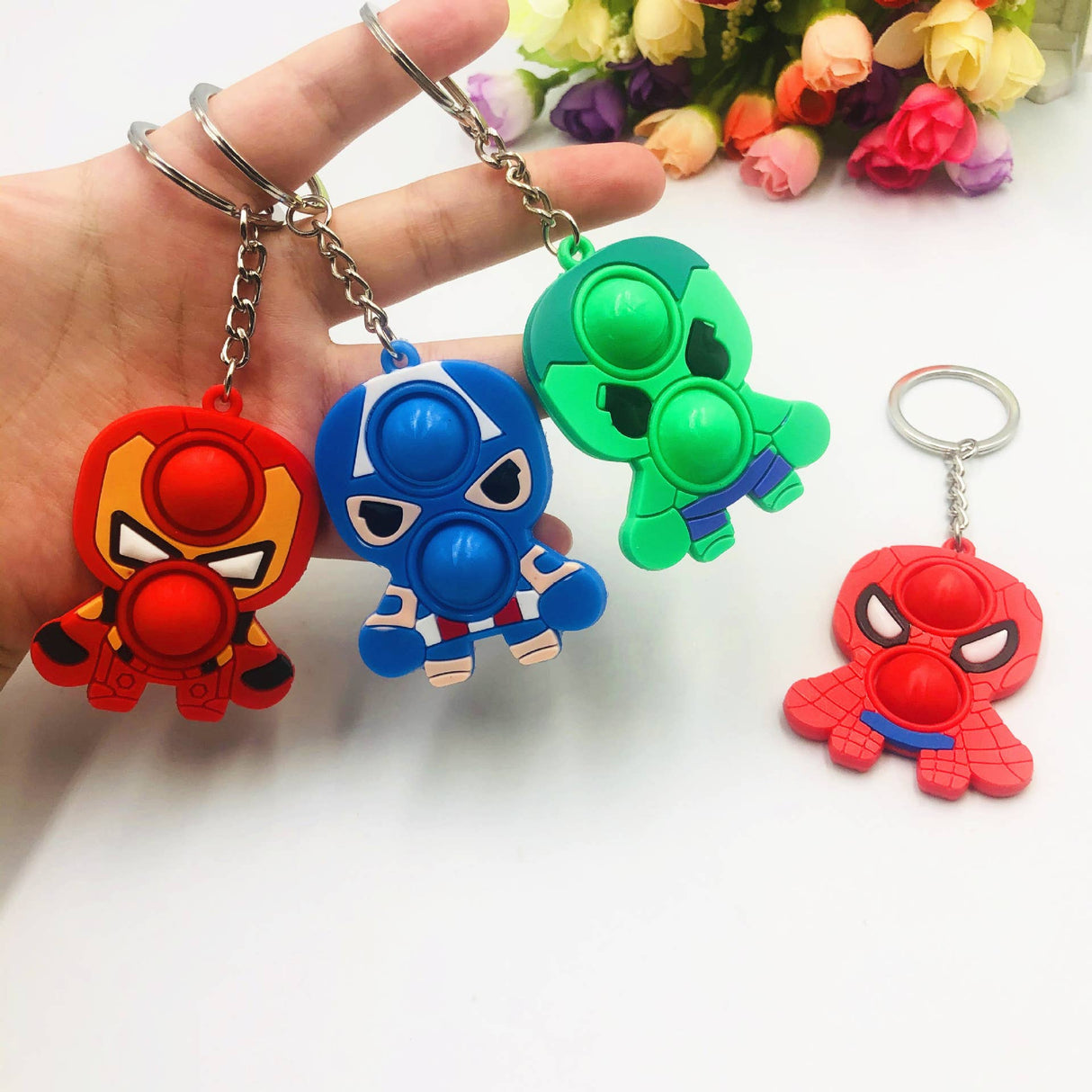 Superhero pop it keychains: red, blue, green, and red for Faire FH2928