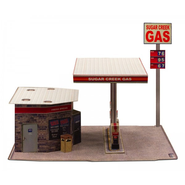 Model kit of a gas station with canopy, pumps, and small store building for Innovative Hobby Supply BK3208