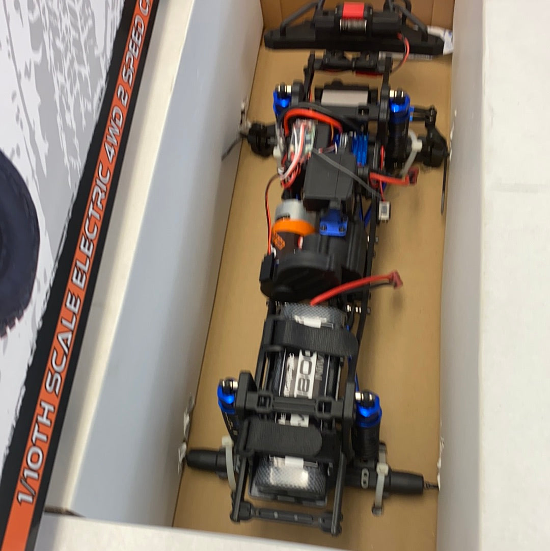 Crawler truck electronics and chassis components laid out on cardboard for IMEX 22020