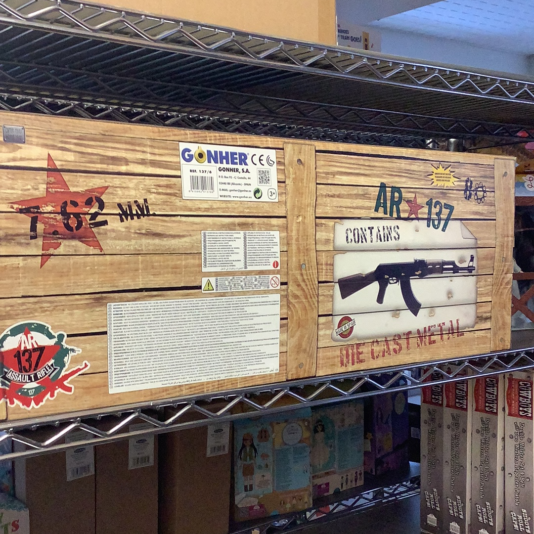 Wooden display board showing AK-47 replica parts and instructions for Gonher 137/6