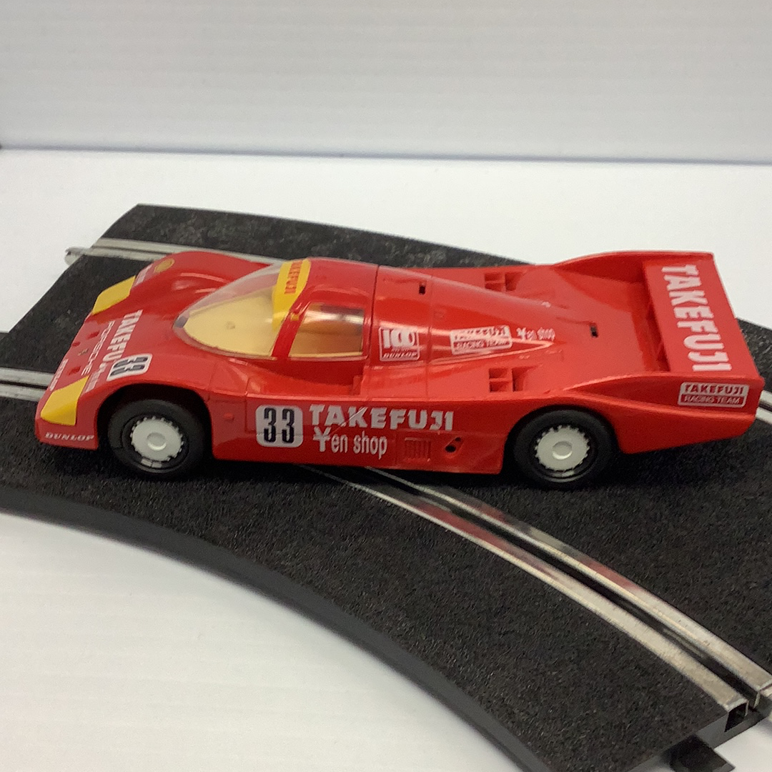 Red Porsche race car model, number 33, on a track section for Scalextric C188