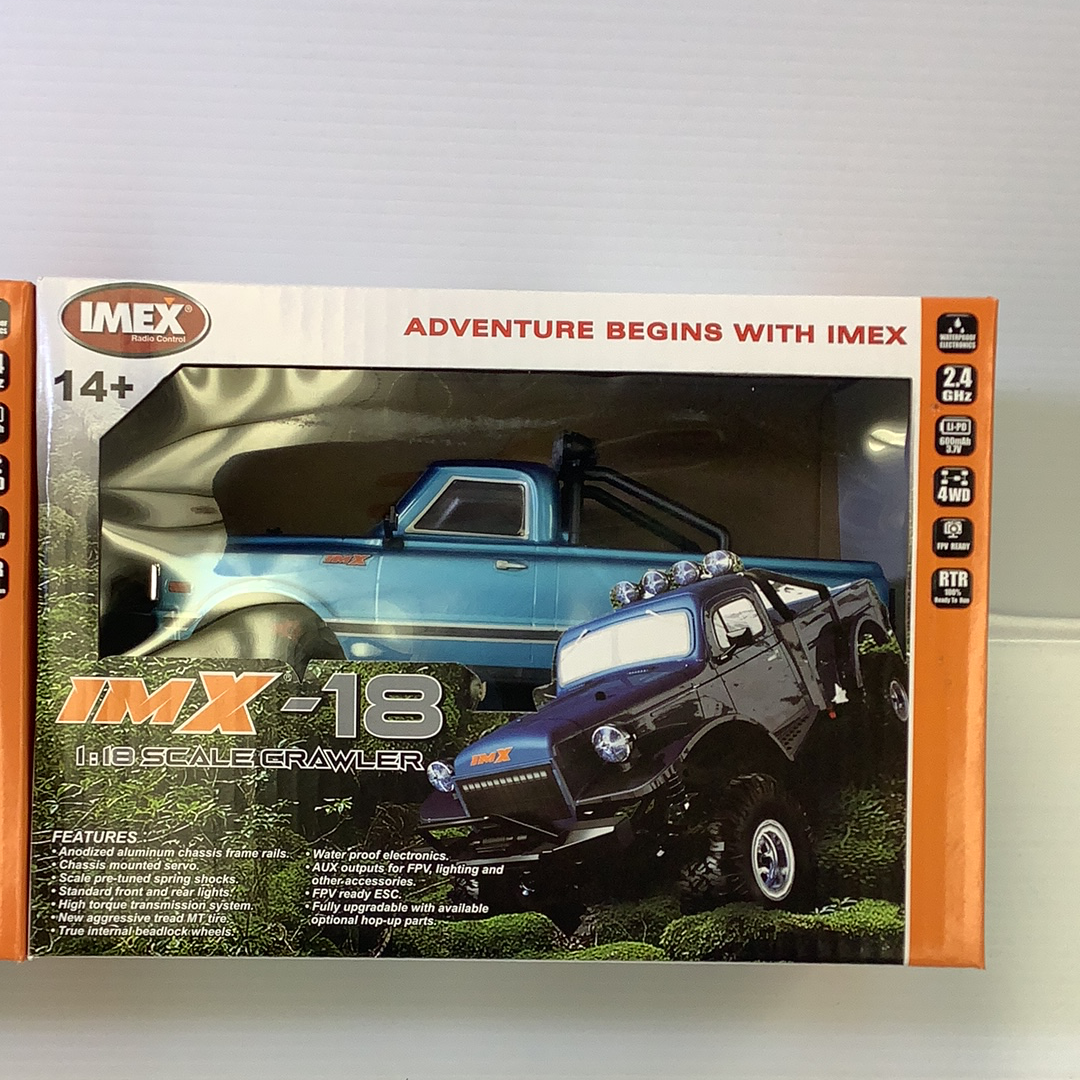 Two remote-controlled crawlers displayed on a box featuring off-road vehicles for IMX IMX25000