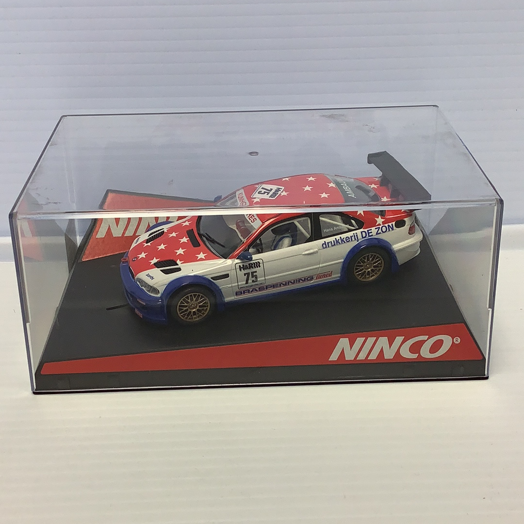 Slot car of a BMW M3 GTR race car in a clear display case for Ninco 50307