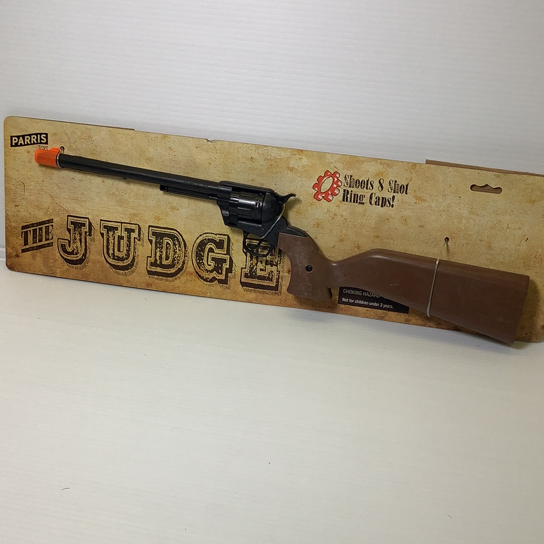Toy rifle with brown stock and cardboard box displaying "JUDGE" for Parris Toys 4731C