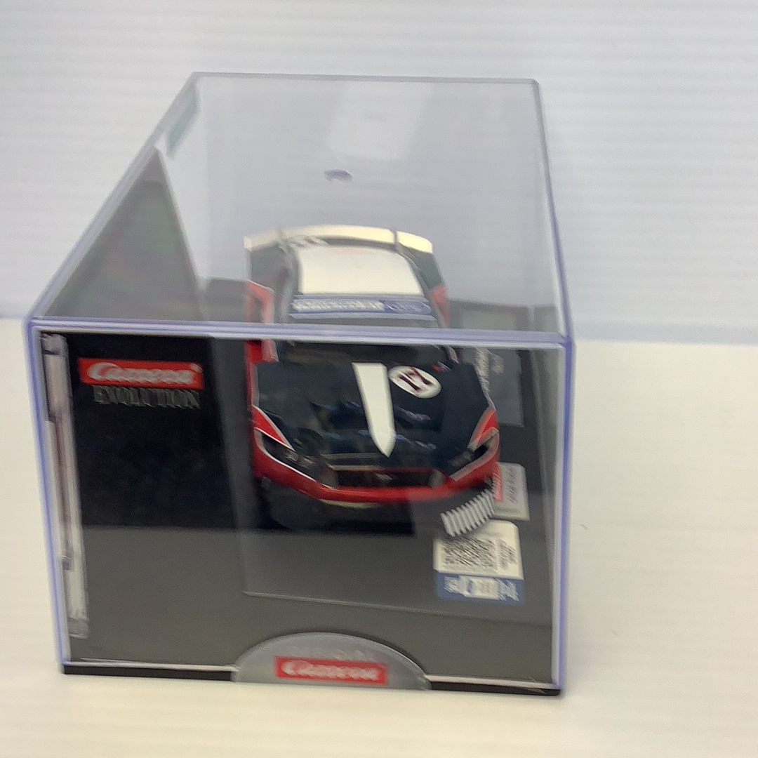 Black and white Ford Mustang model in clear display case for Carrera Evolution 27636