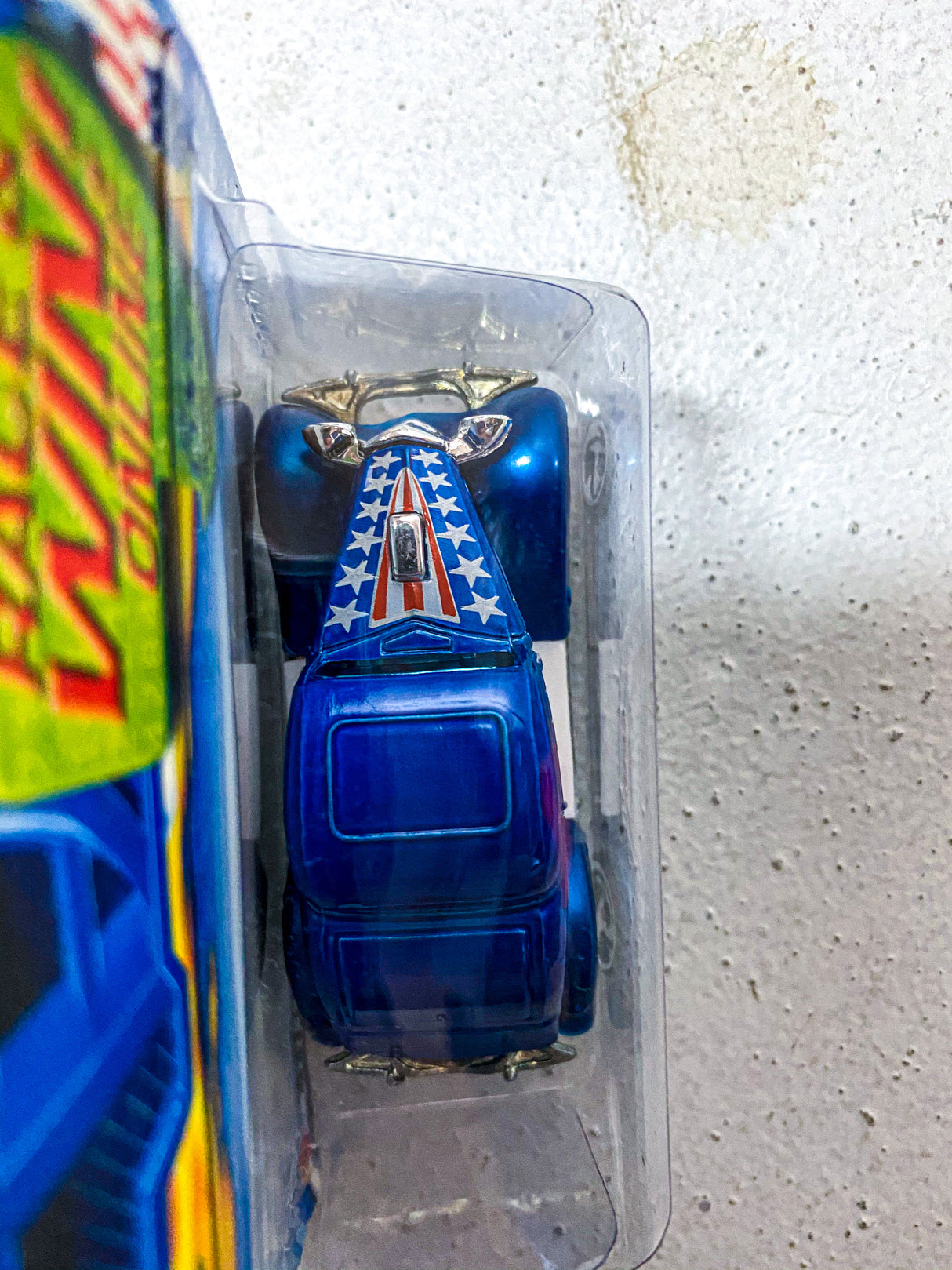 Blue Hot Wheels car in clear plastic packaging against a light background for 080