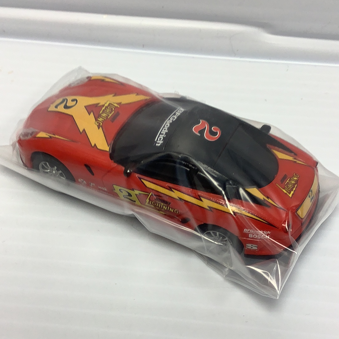 Red slot car with yellow lightning bolt graphic for Johnny Lighting JL2010