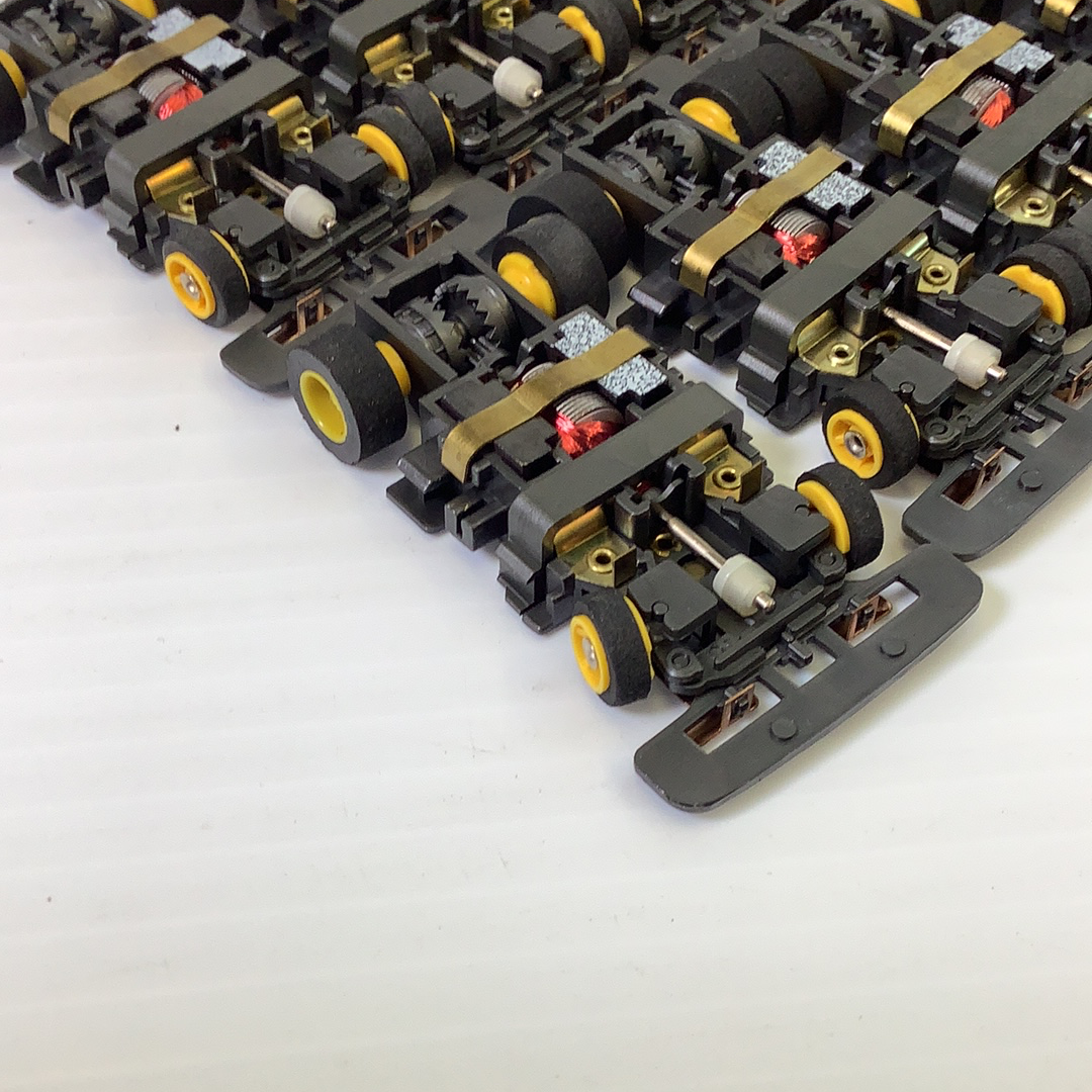 Assortment of black and gold electrical chassis components for Tyco TCR TCR1501