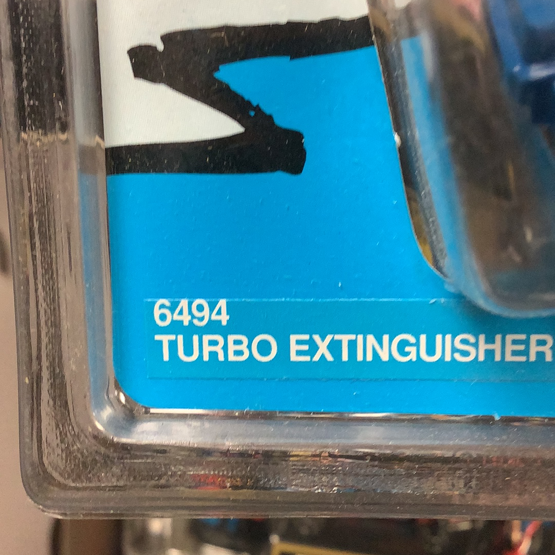 Label showing "6494 TURBO EXTINGUISHER" for racing equipment for Tyco